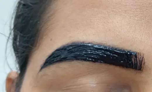 Close-up of professional eyebrow tint application at Eternal Beauty