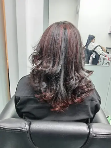 Red-brown balayage curls hair colour result at Eternal Beauty Deira