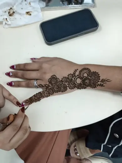 Floral henna design being applied at Eternal Beauty ladies salon