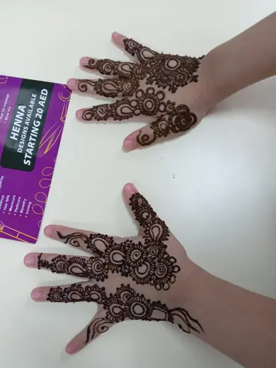 Intricate henna pattern on hands at Eternal Beauty, designs from AED 20
